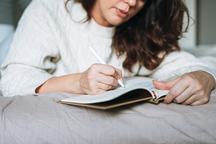 woman writing in a book