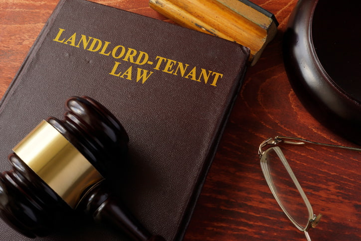 Scales of justice and legal documents representing Michigan landlord-tenant law